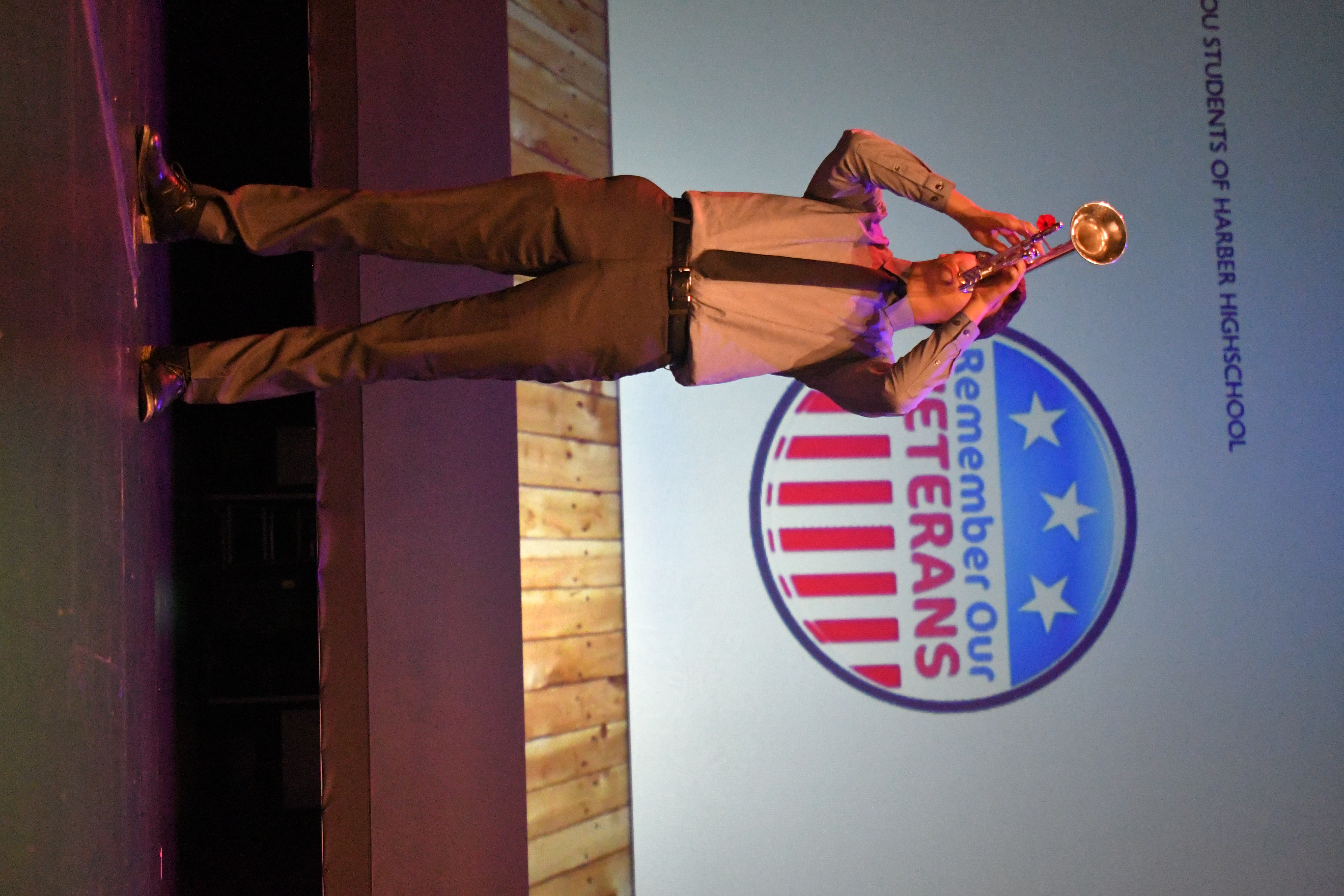 A stage presenter clapping