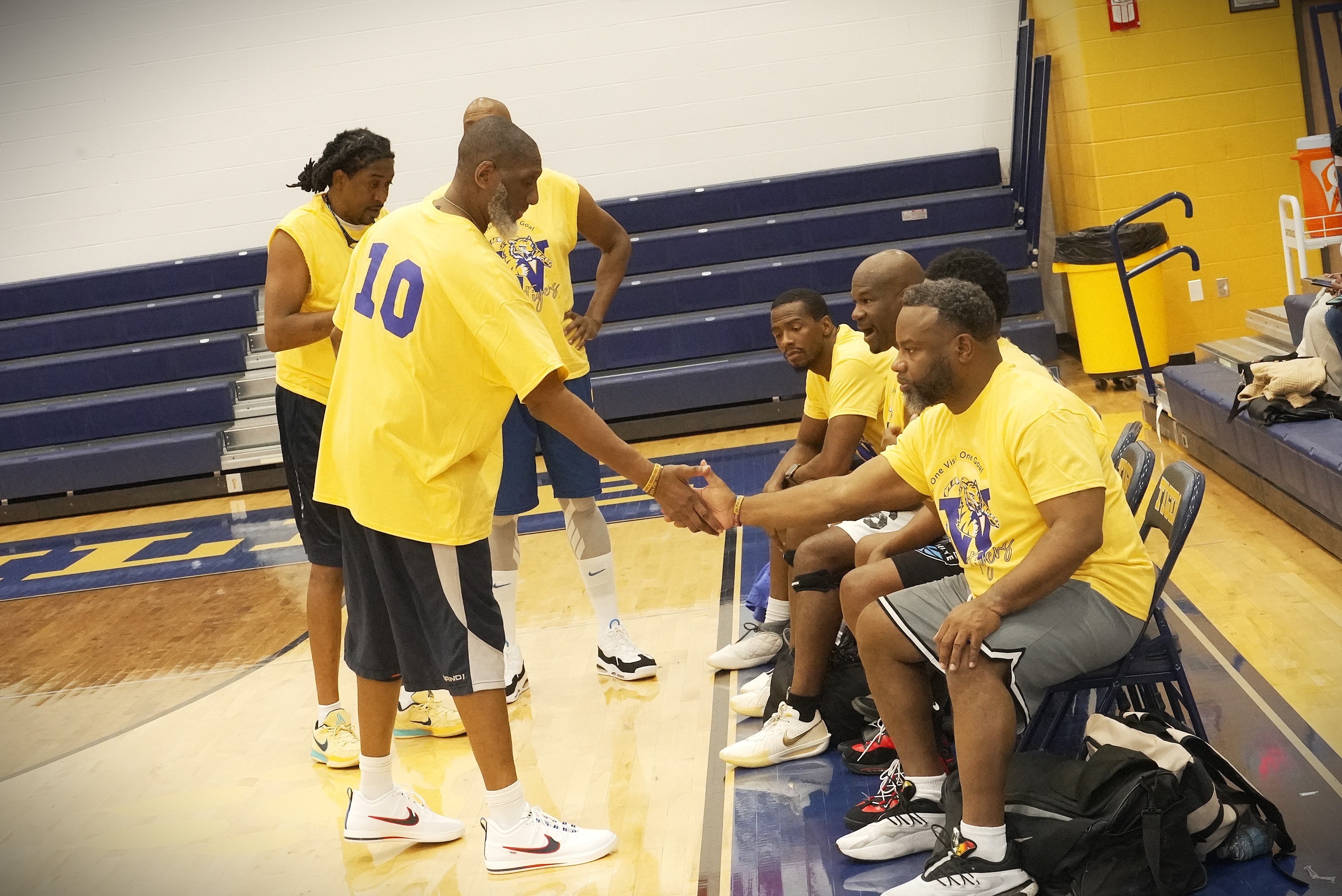 alumni basketball players shaking hands