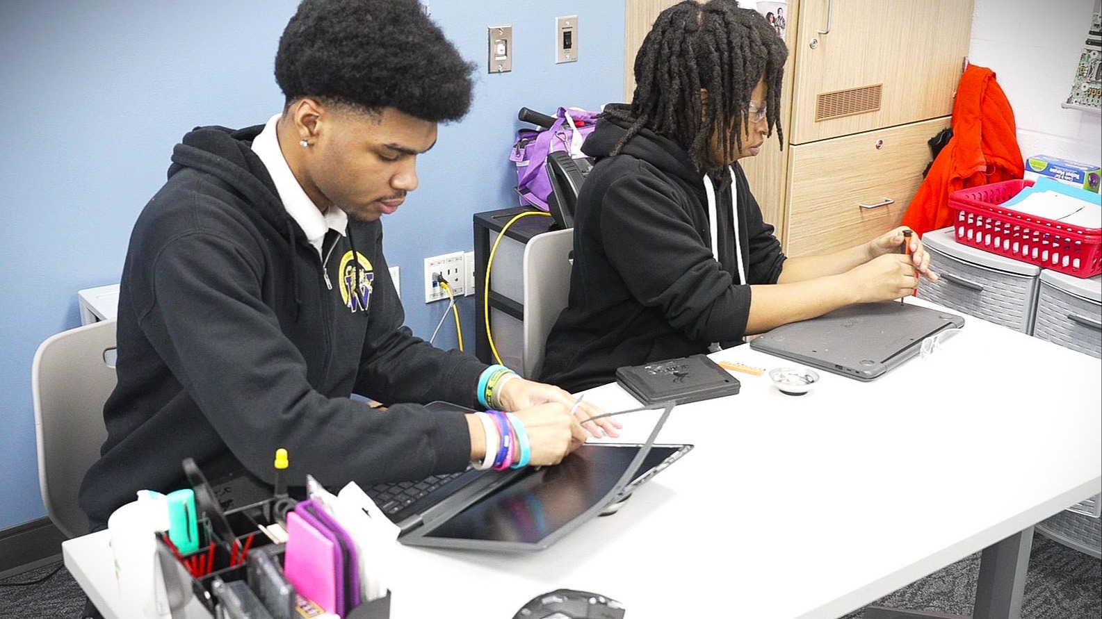 image of cybersecurity students fixing computers