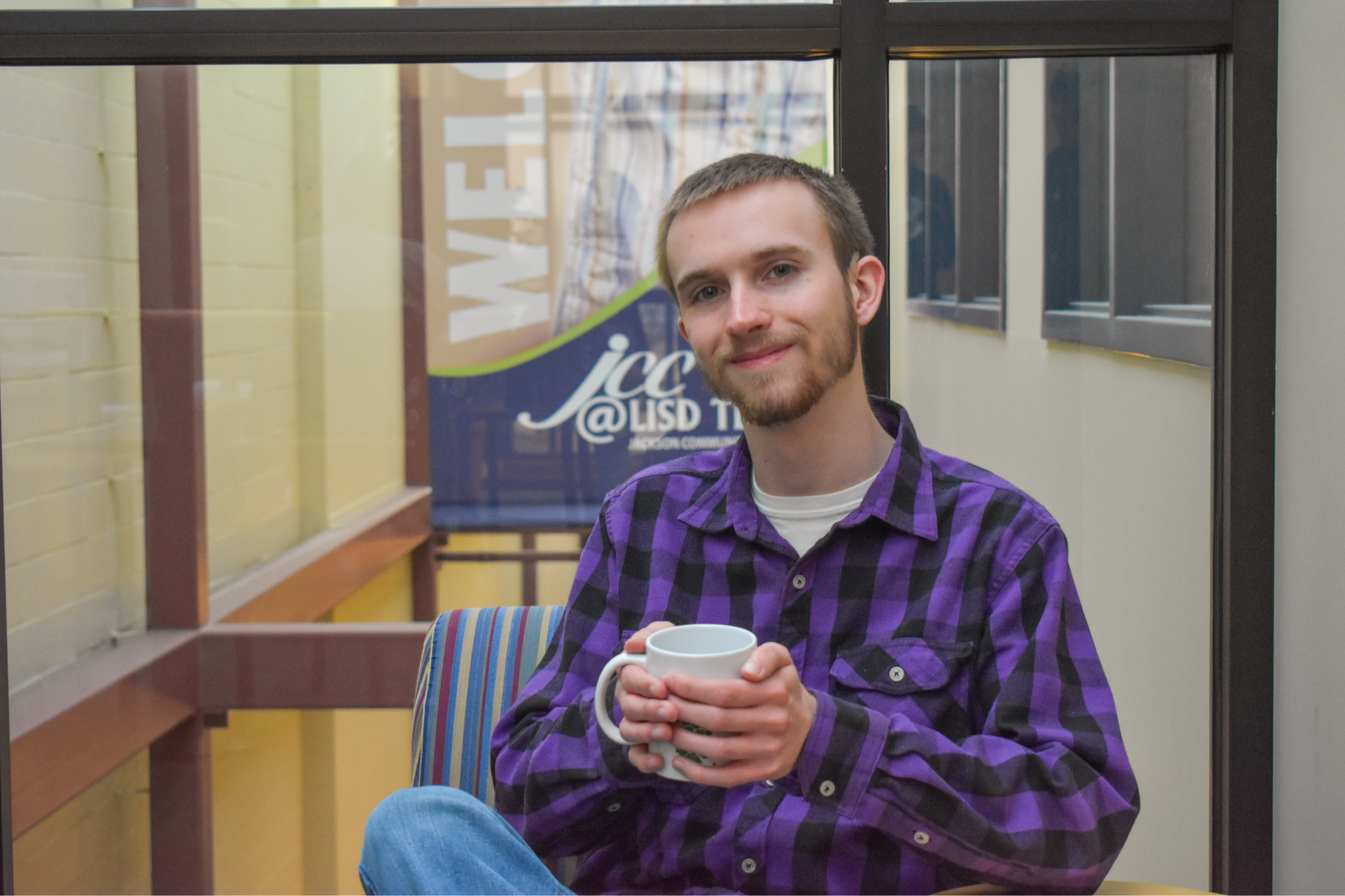 student holding coffee mug