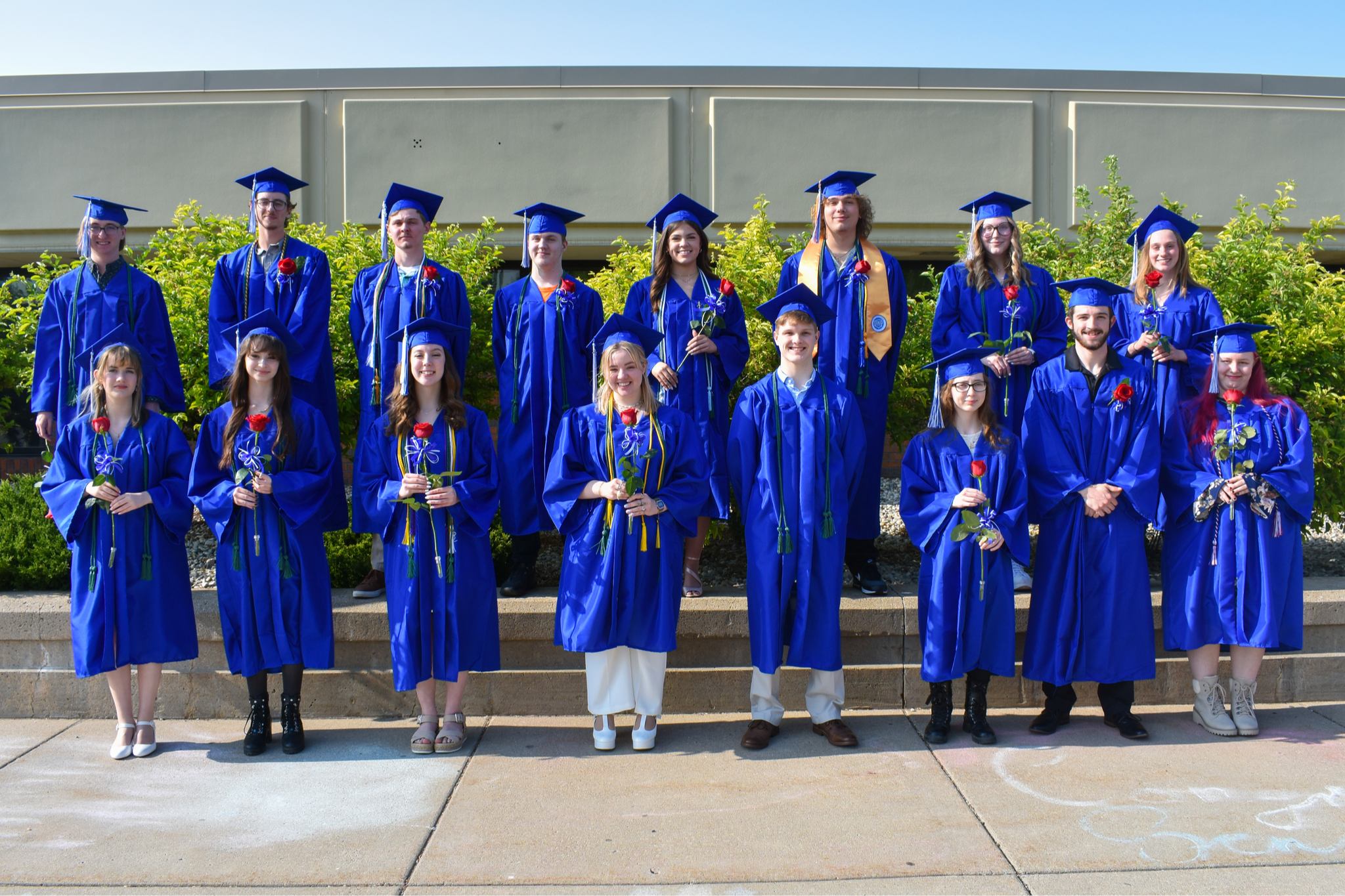 Graduates outside in caps and gowns