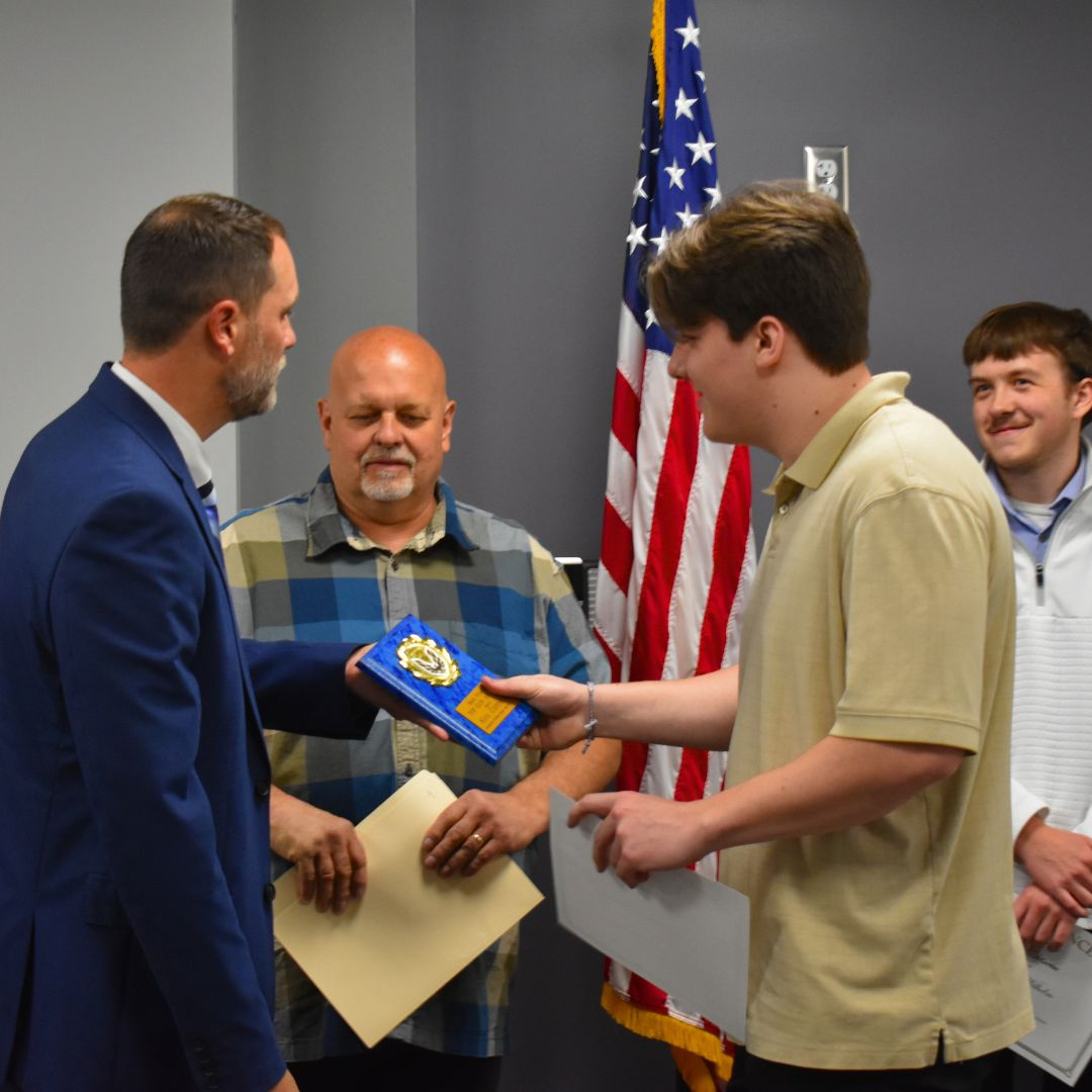 Top Gun Award Winner receiving plaque