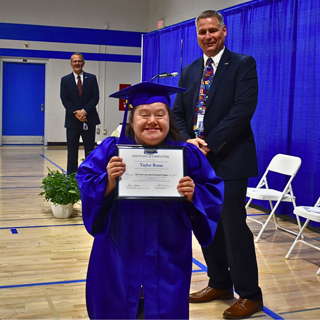 Student posing with certificate