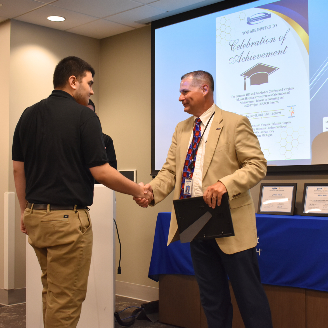 Project Search graduate shaking Superintendent's hand