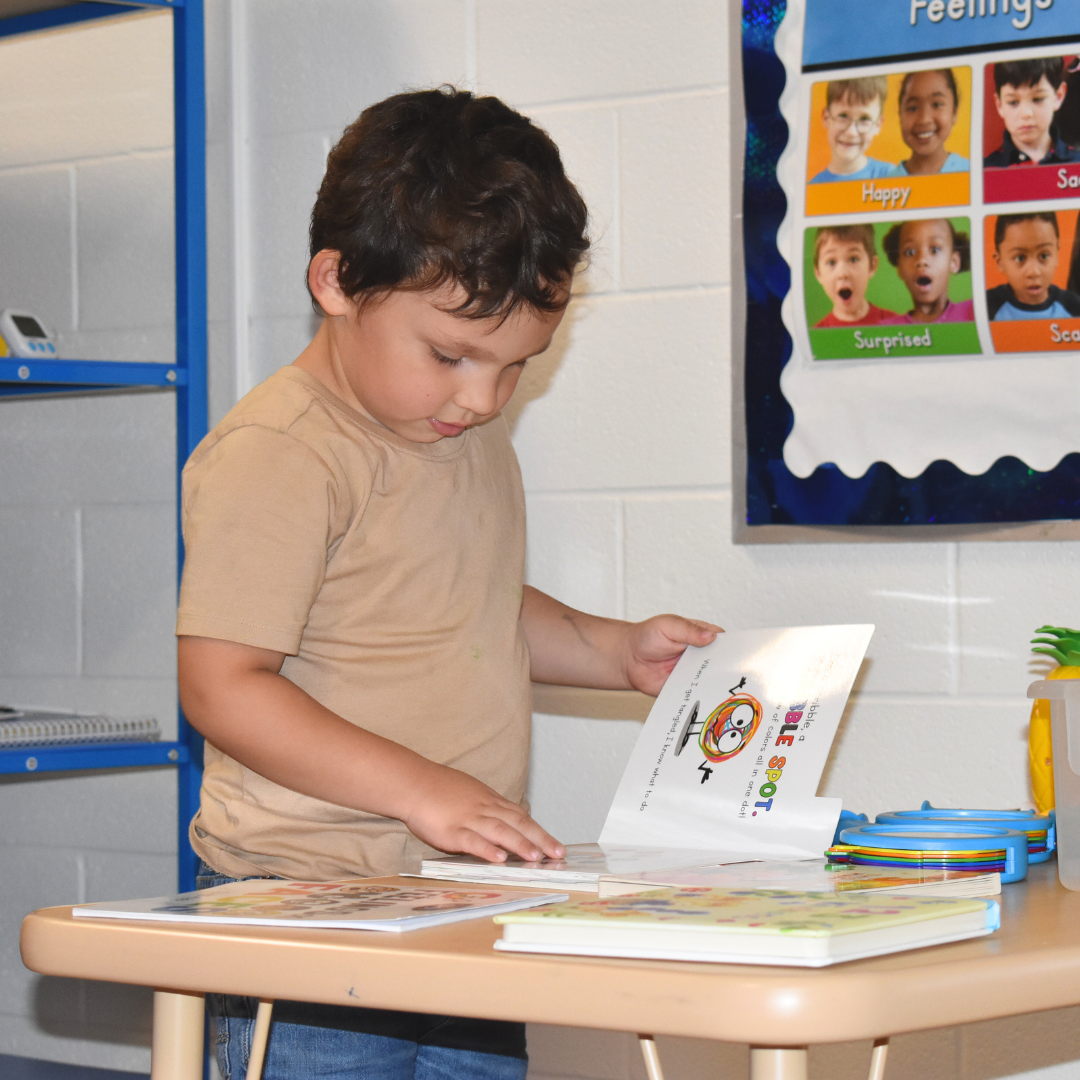Child reading a book at family night