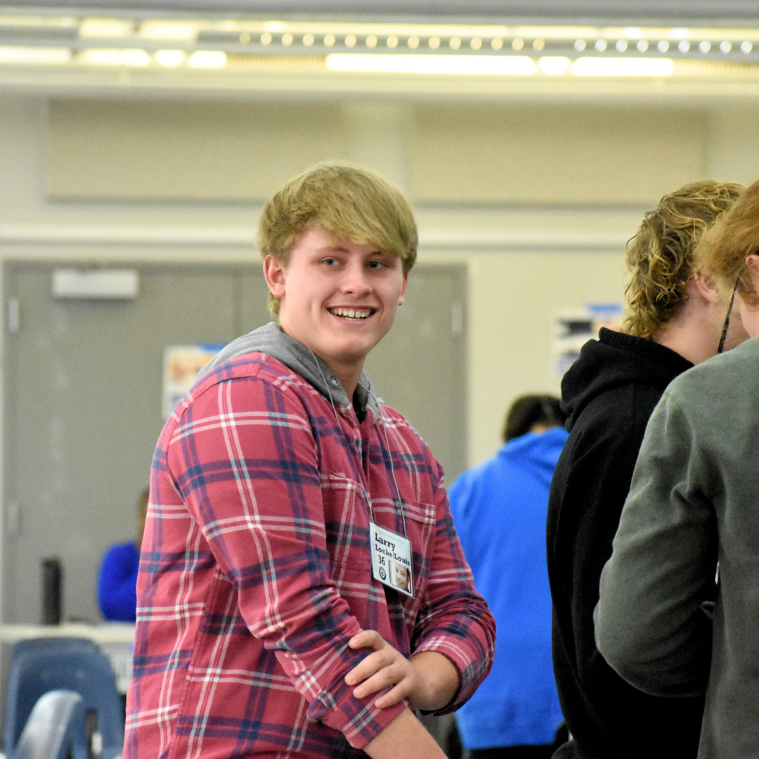 Poverty Simulation Event student reacting after having belongings stolen in simulation