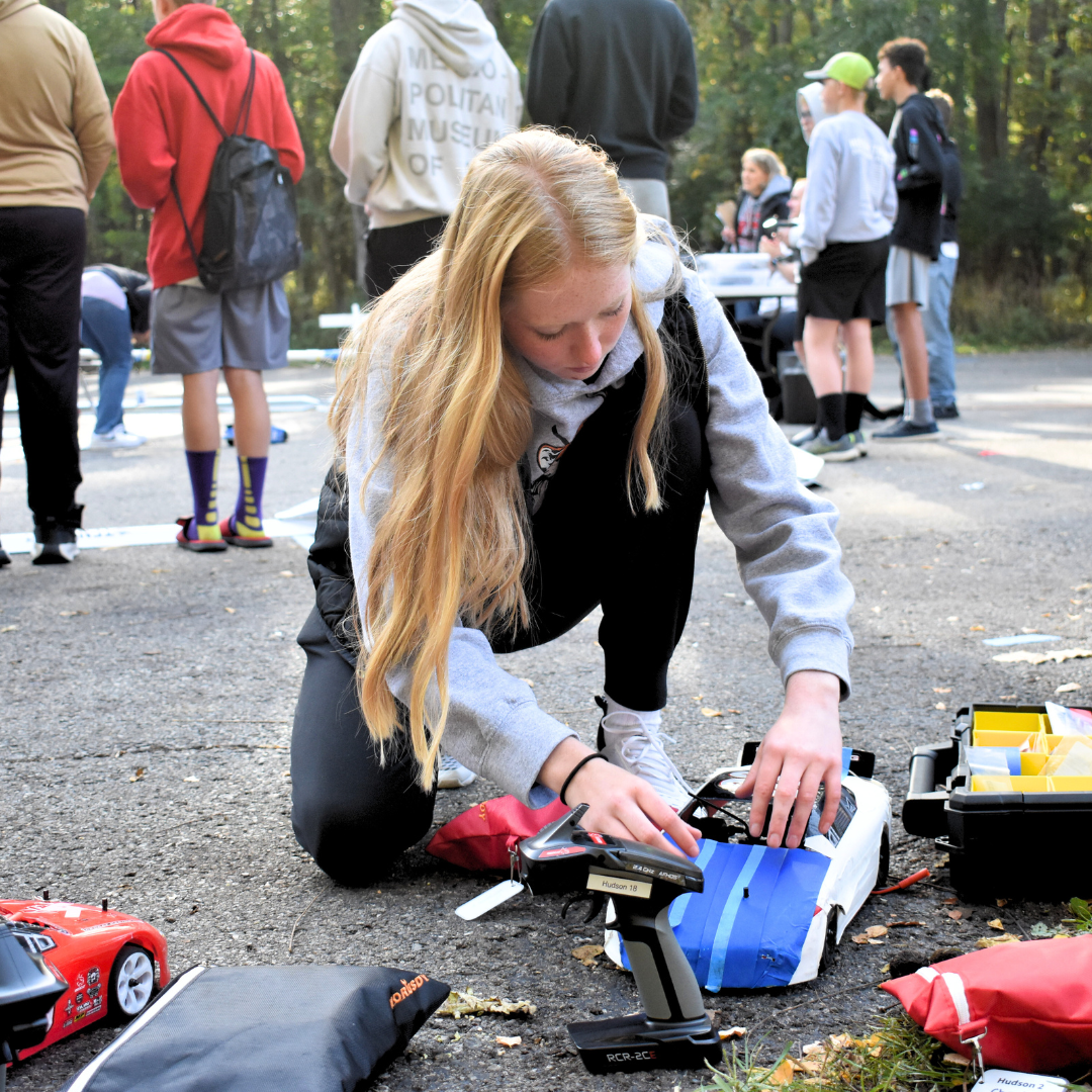 Student fixing car at Ten80 RC Racing Event