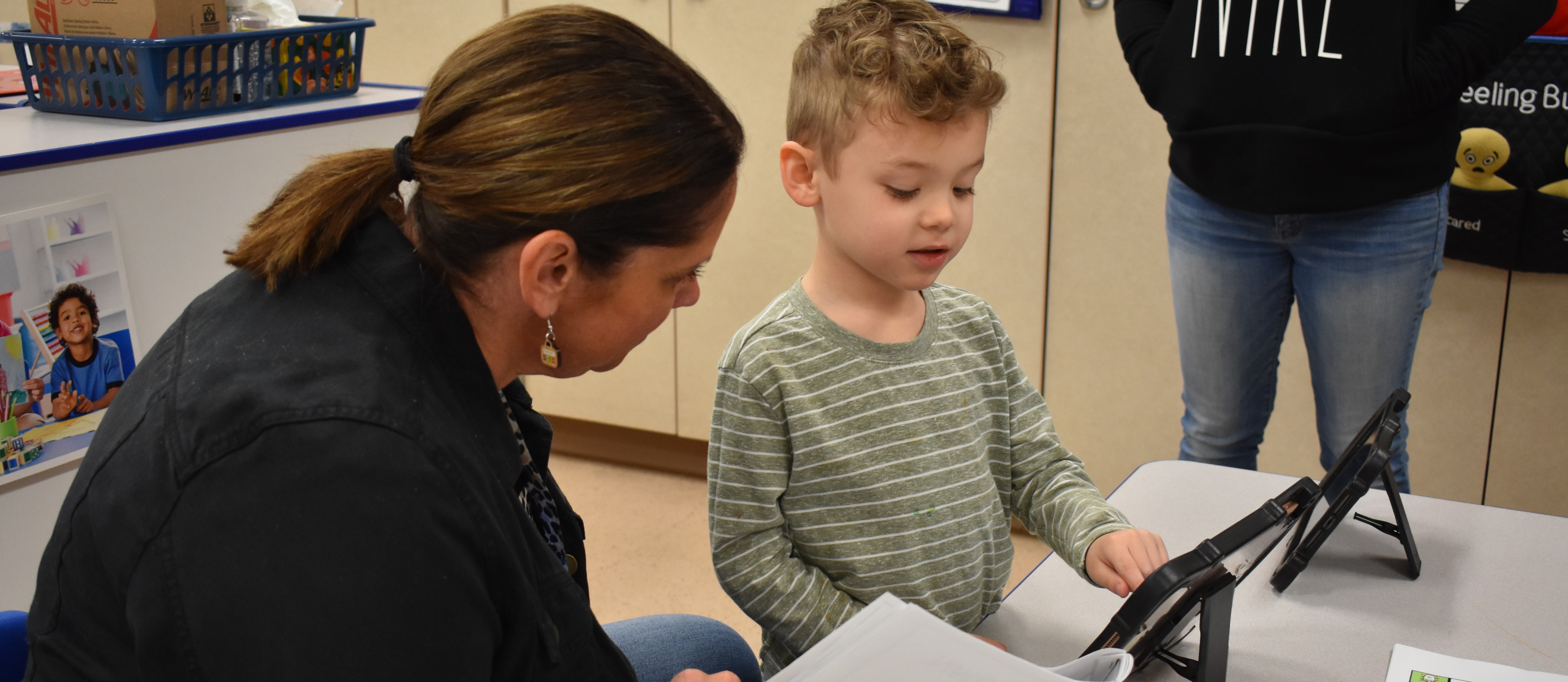 An instructor and student using an ipad communication device