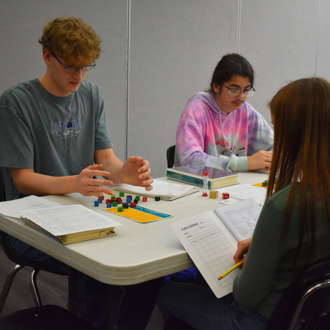 3 students in the middle of an equations game