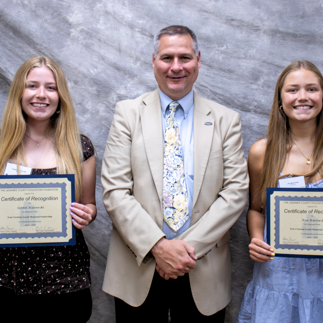 Photo of superintendent and two students who won scholarships