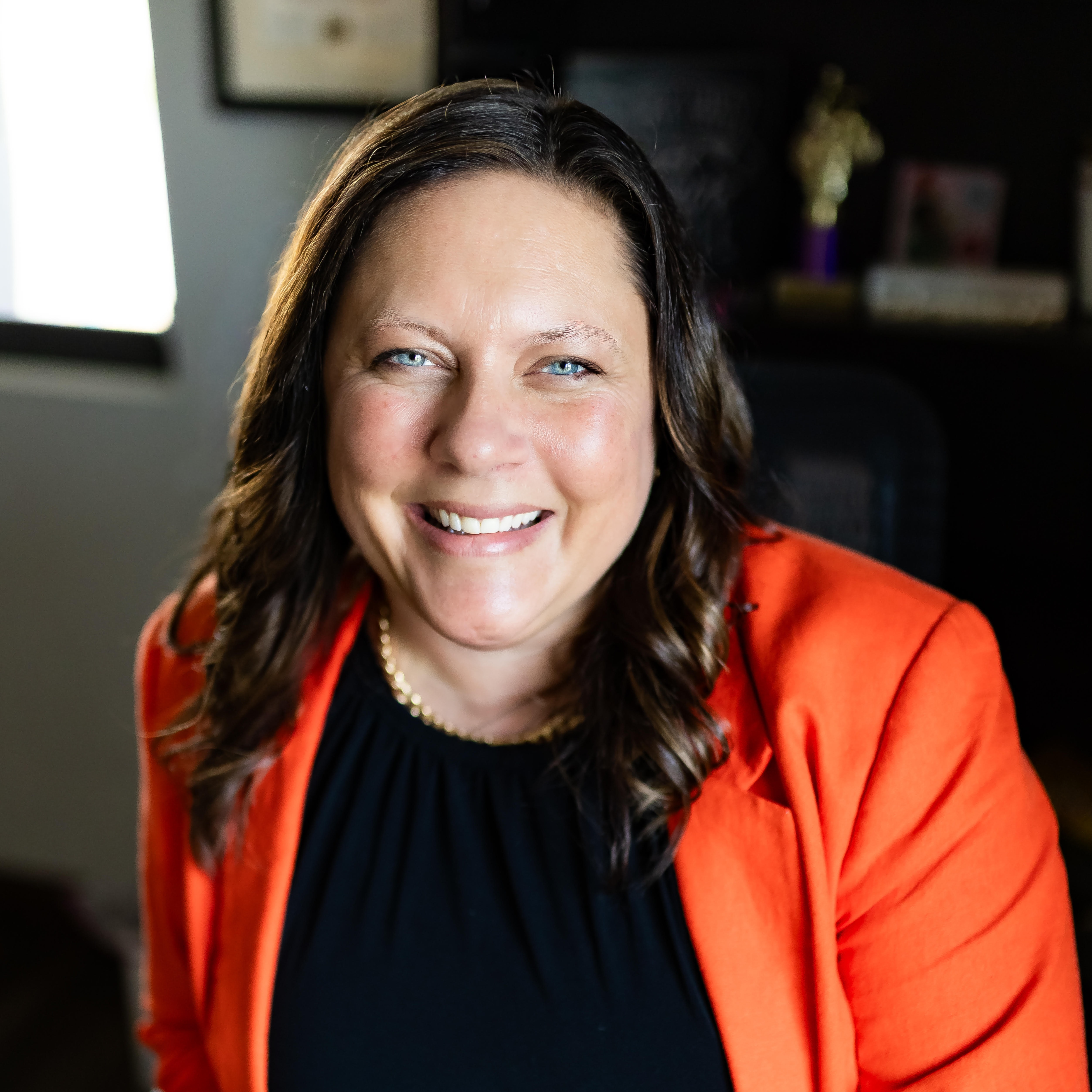 Woman with a black shirt and orange jacket