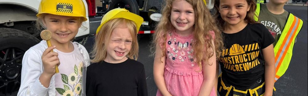 smiling students wear construction hats
