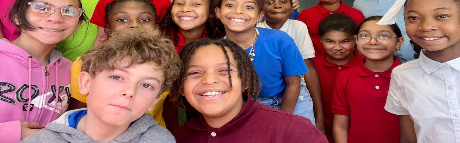 smiling students goof around in front of the camera