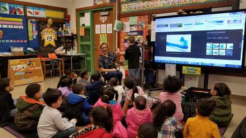 teacher and students in the classroom projecting the class