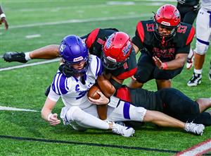 Two football players collide on field.