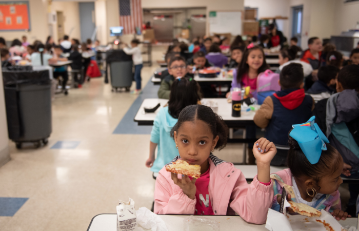 Children enjoying a meal together in the school cafeteria.