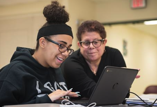 student and teacher in a laptop