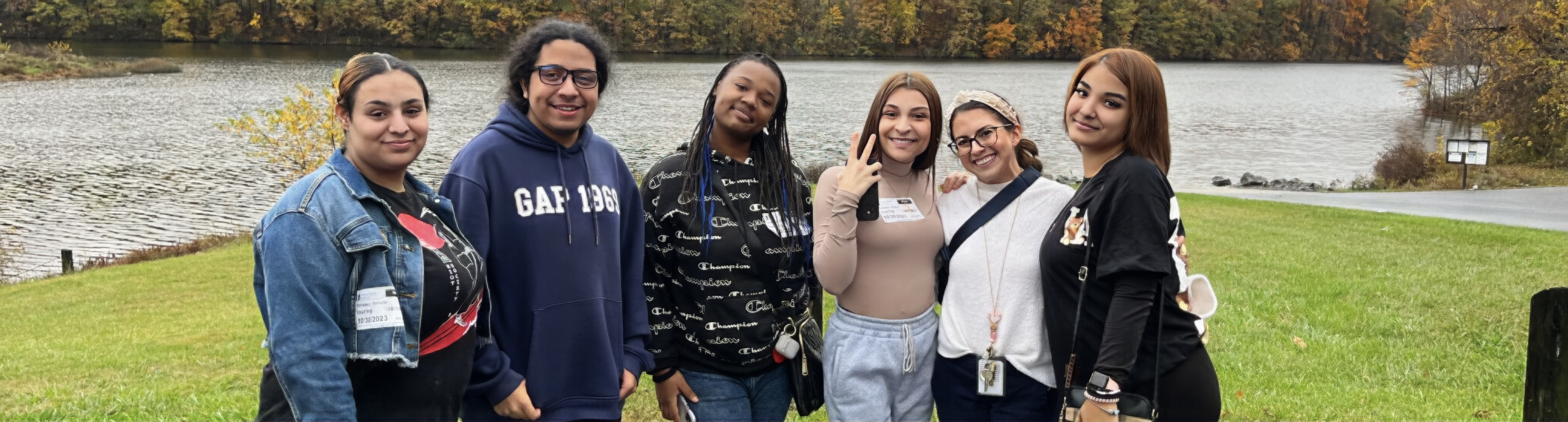 Students standing together in front of lake