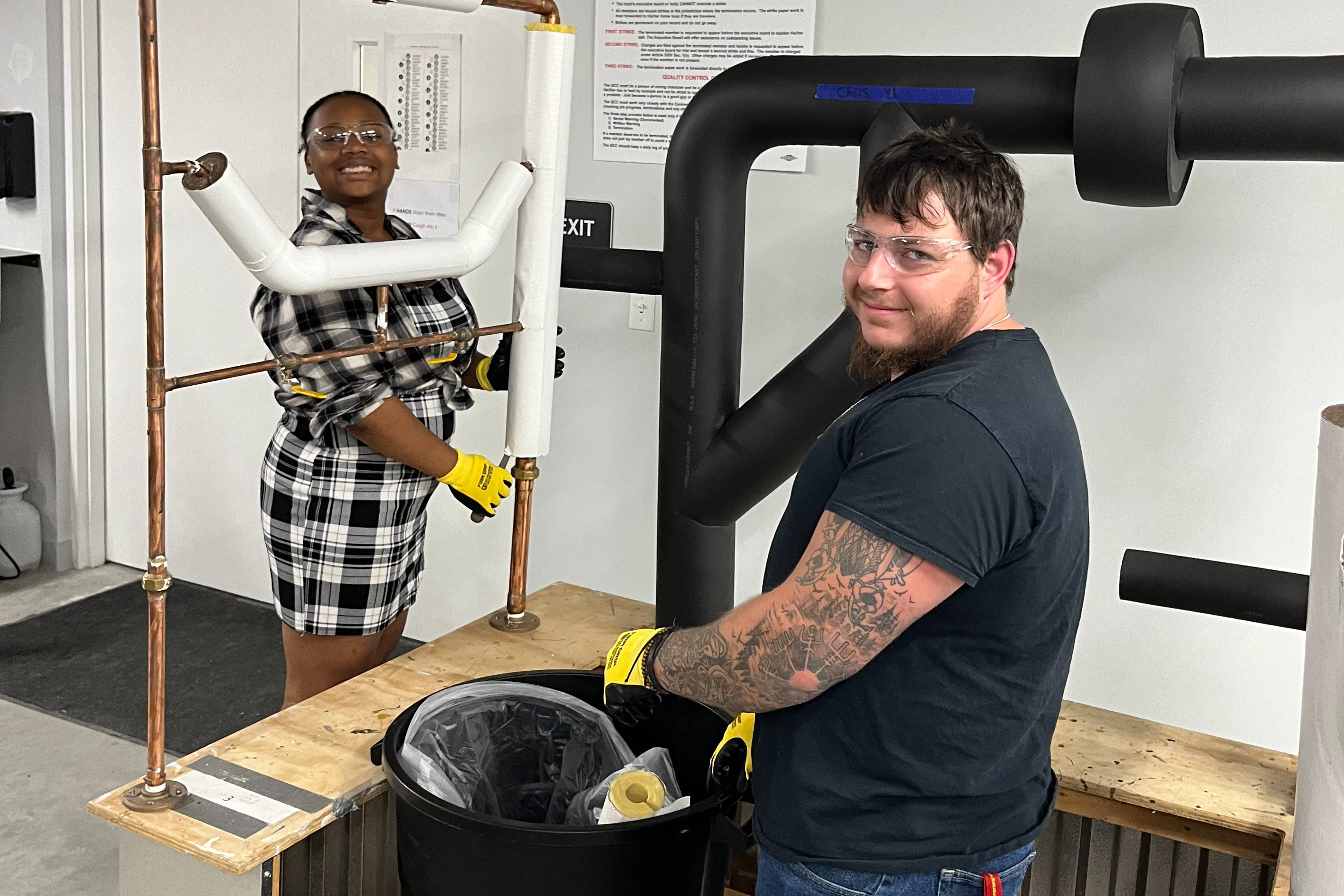 Student Girl and Student Boy fitting pipes