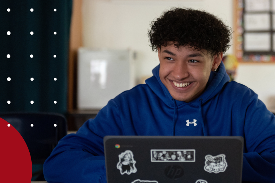 Boy smiling at his computer