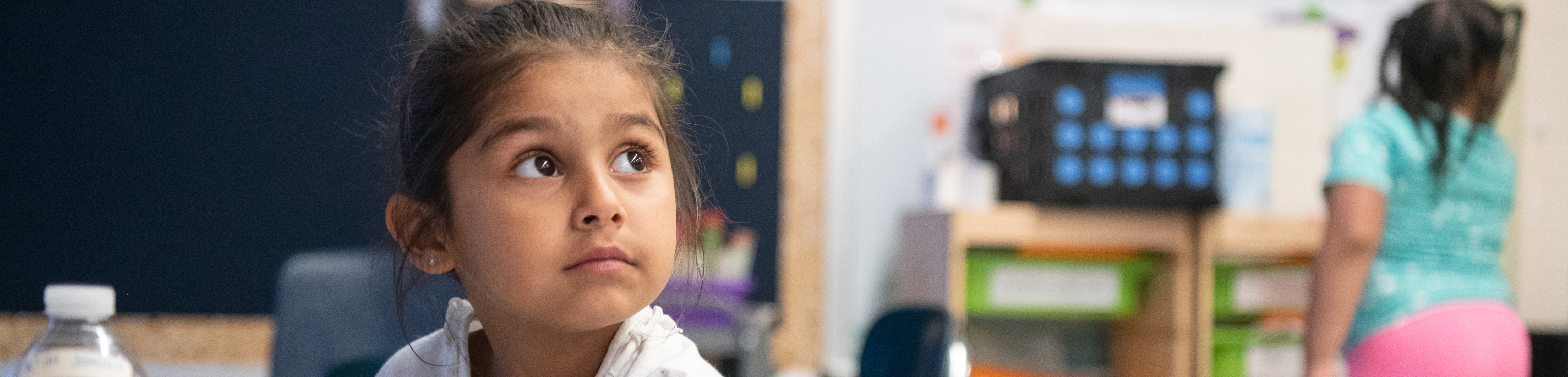 girl looking up at teacher