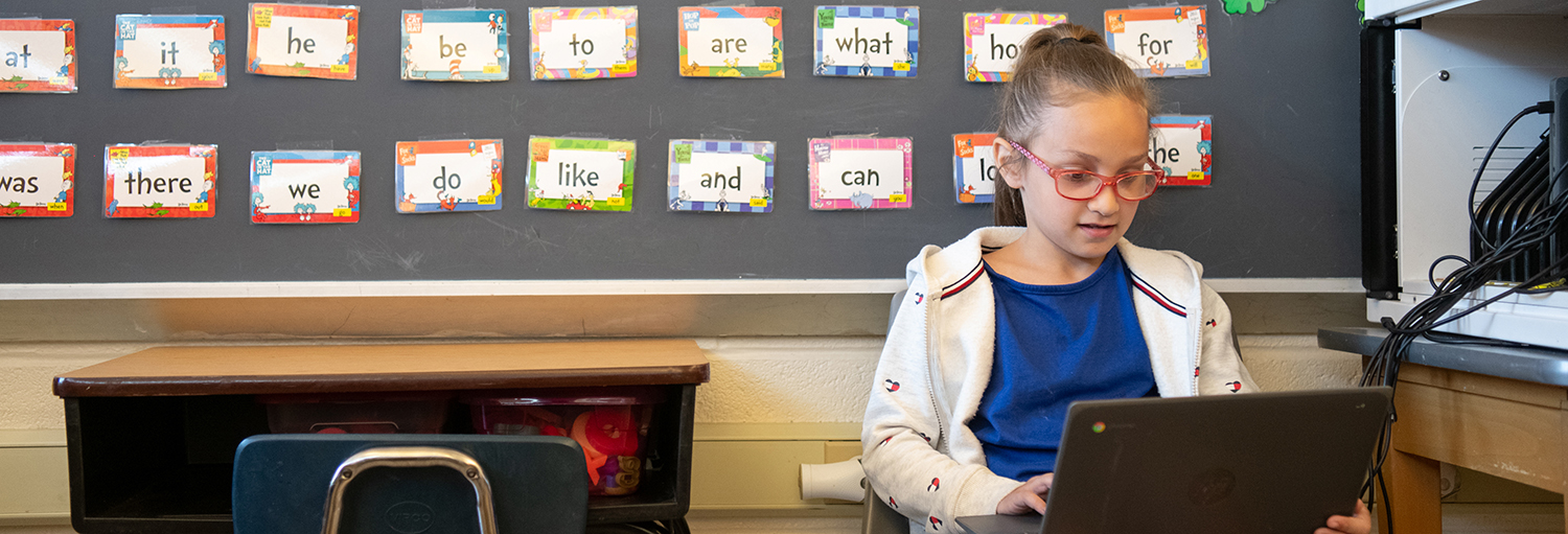 girl on laptop in classroom