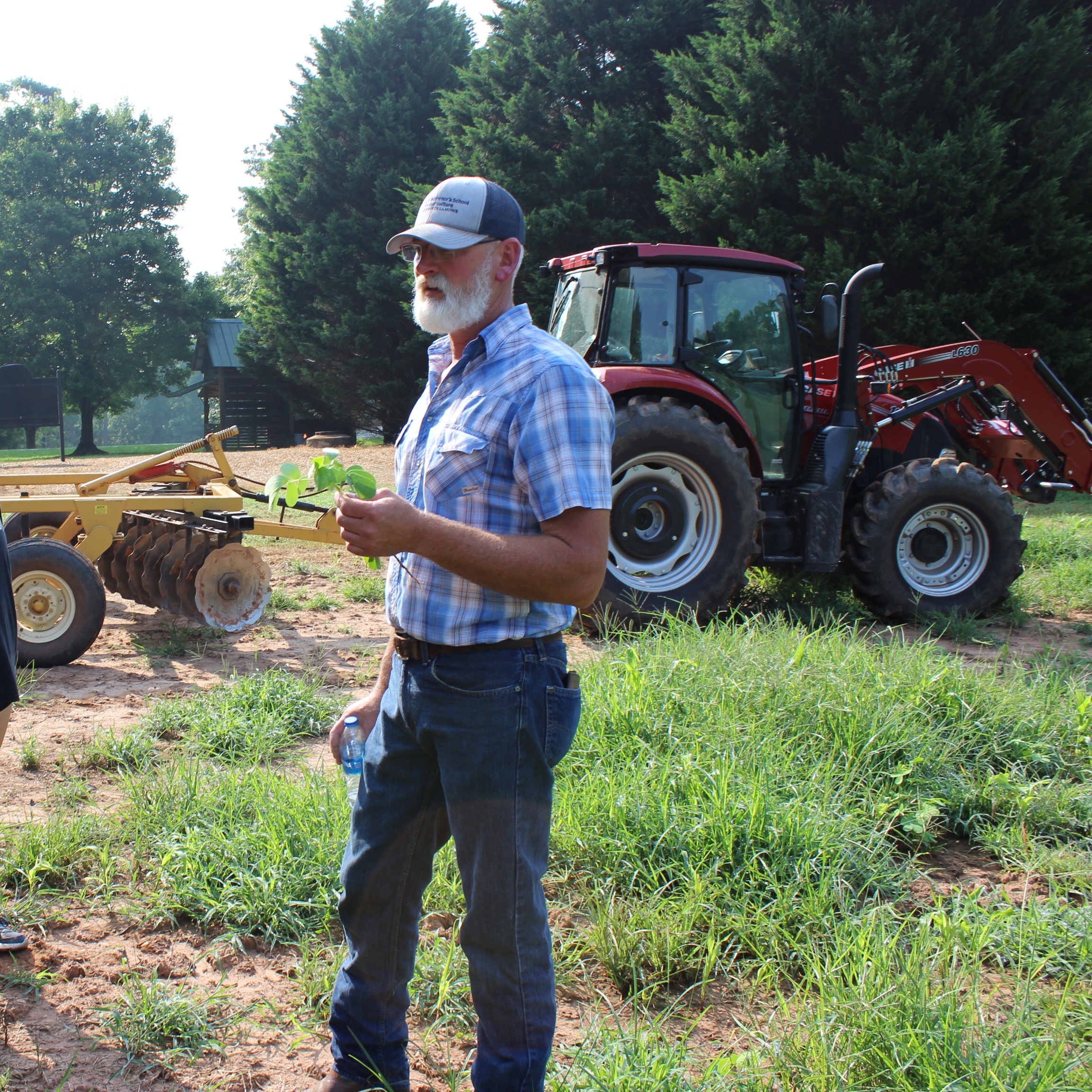 Farm manager Eric McCall talks with summer camp students. 