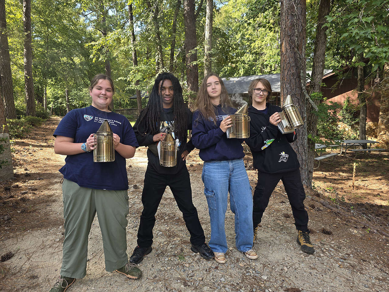 Students prepare to employ the smokers to safely enter the hives.