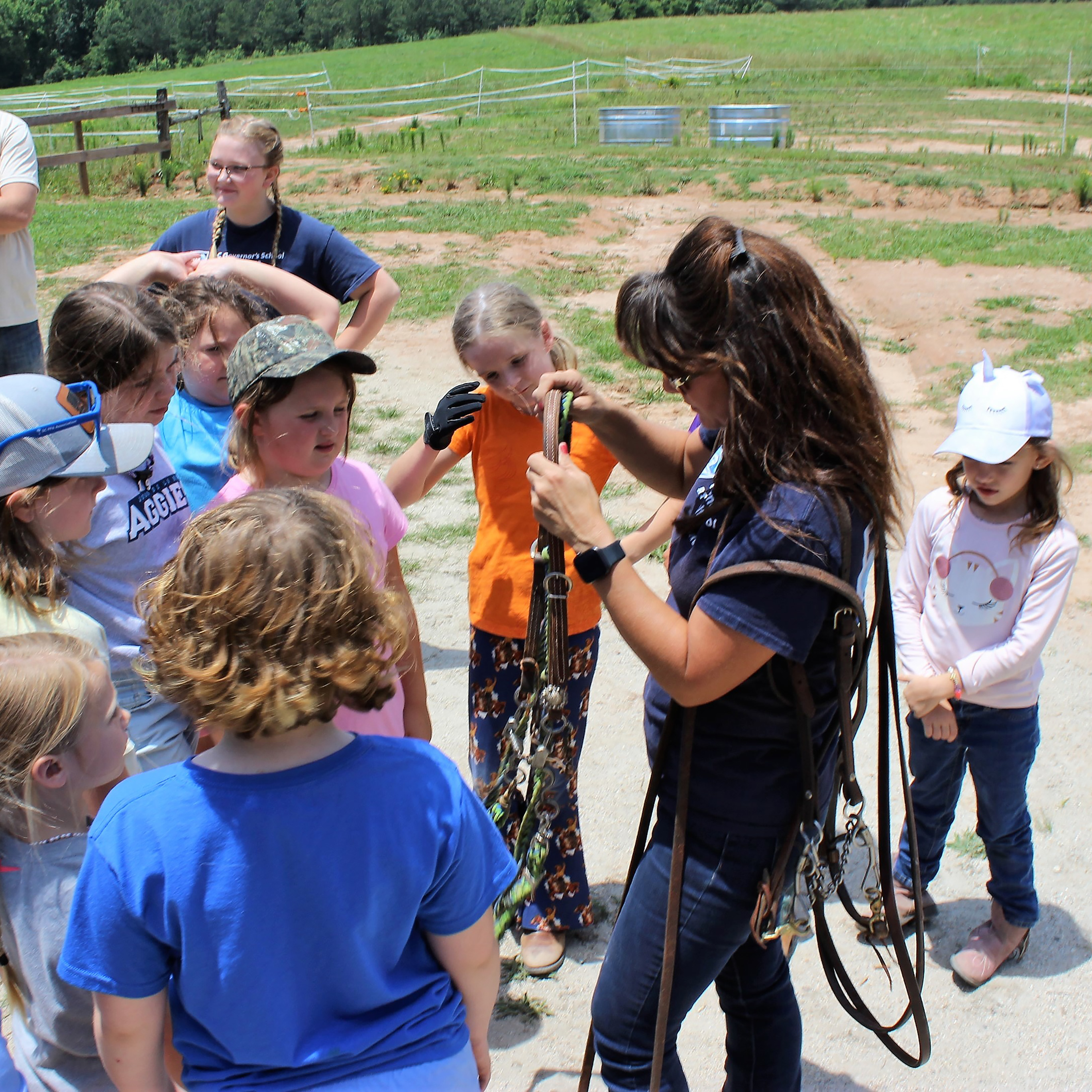 Our equine team demonstrates the use of various tack to summer campers.