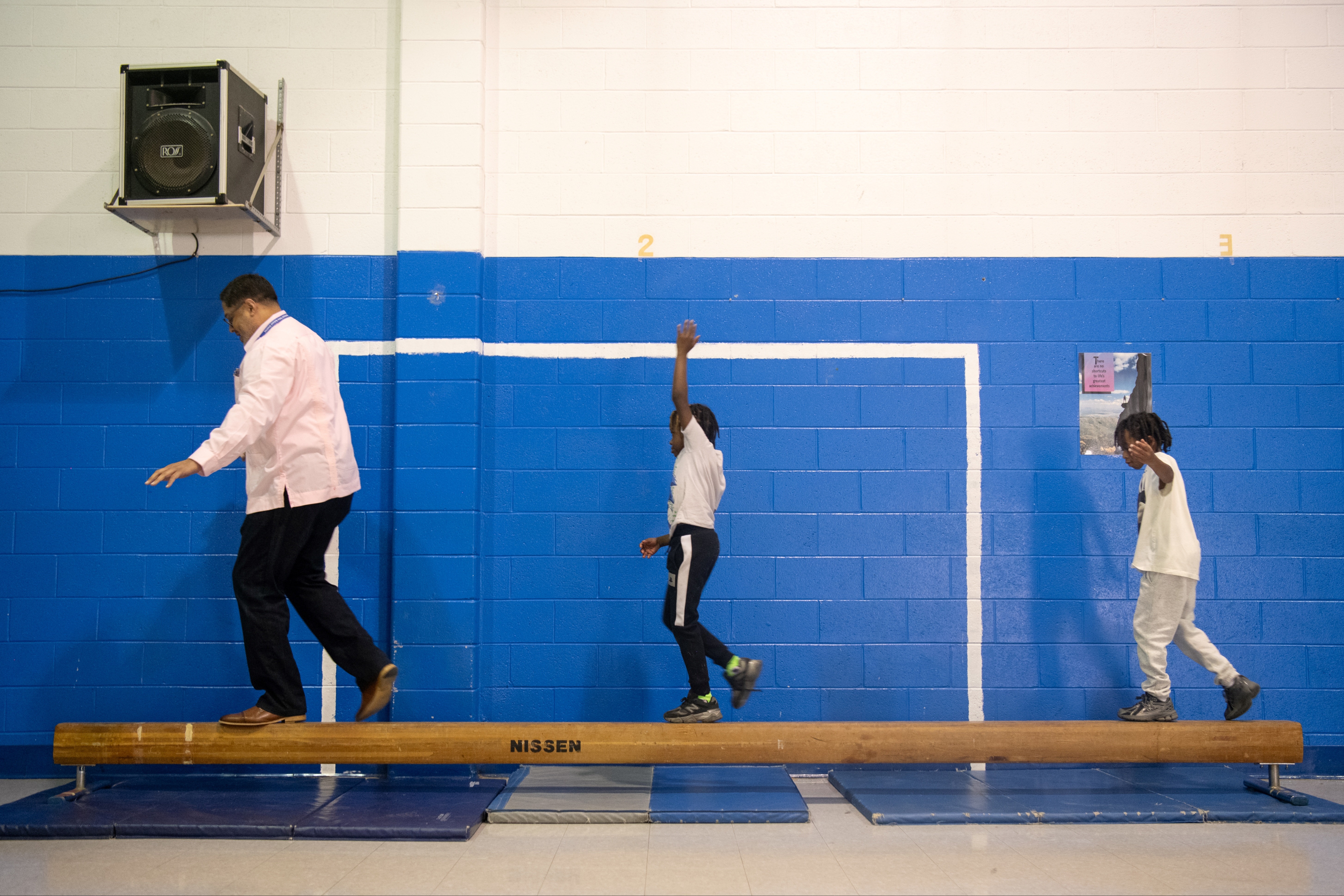 Students and staff on balance beam