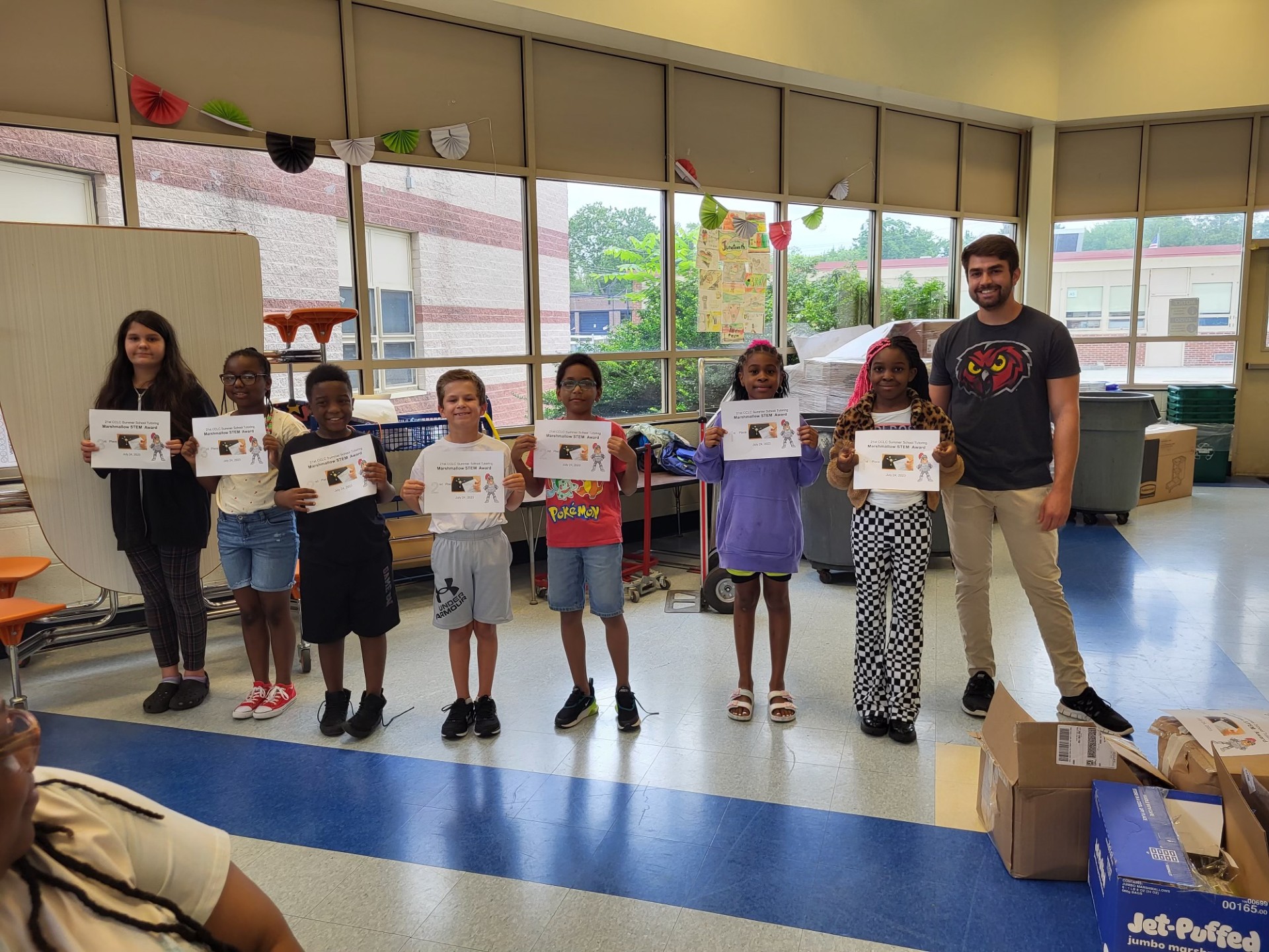 students holding certificate for STEM activity