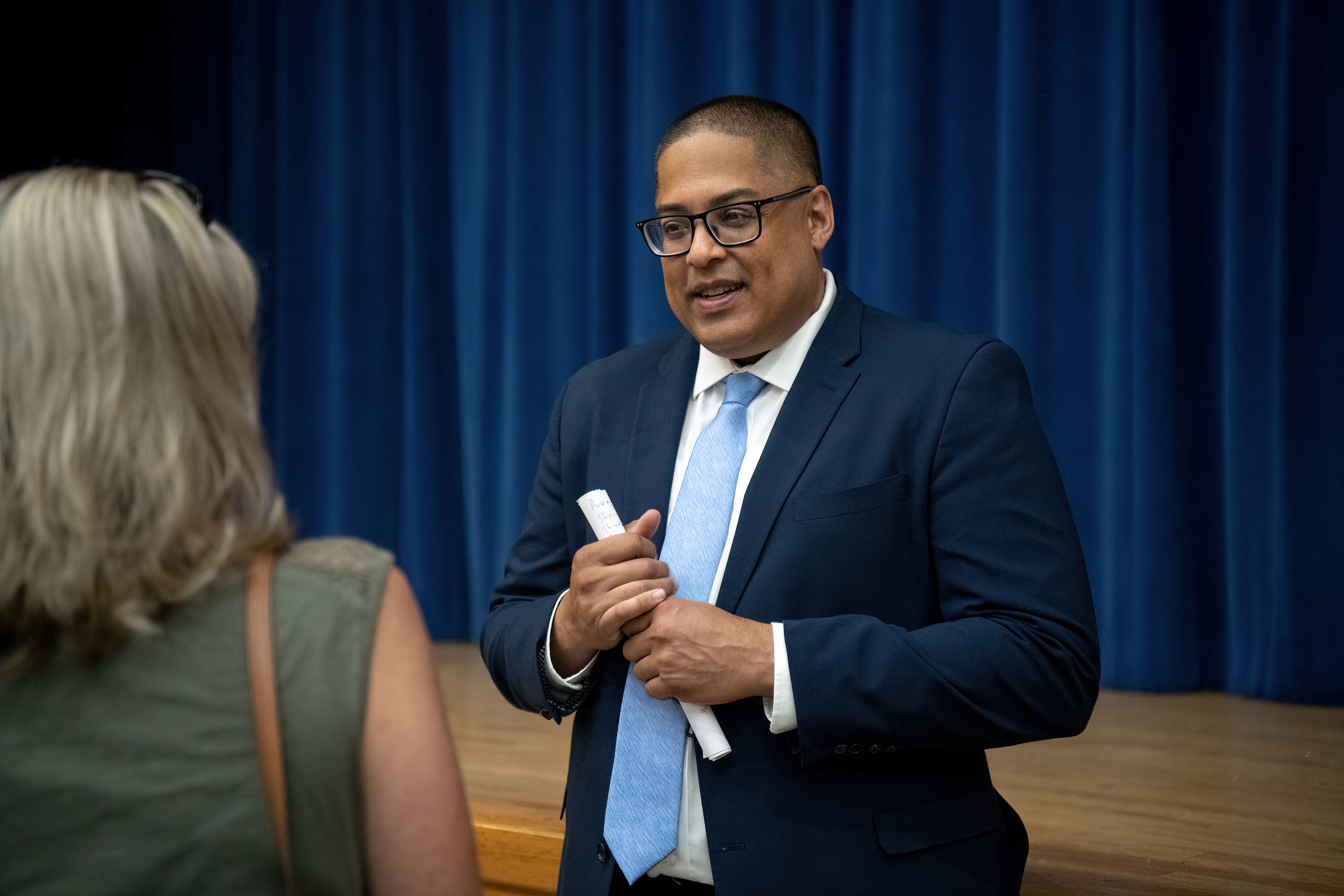 Superintendent Dr. Sanchez talking with a staff