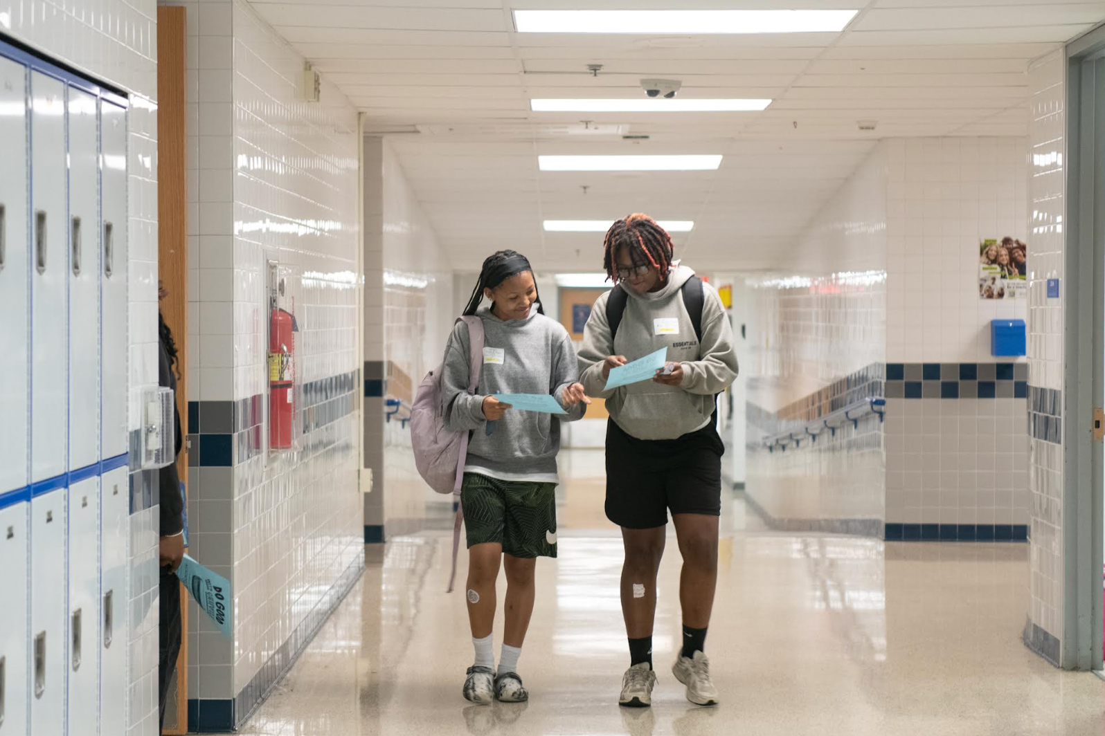 two students walking through hallway