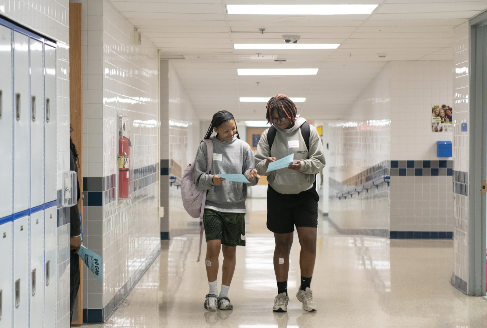 two students walking through hallway