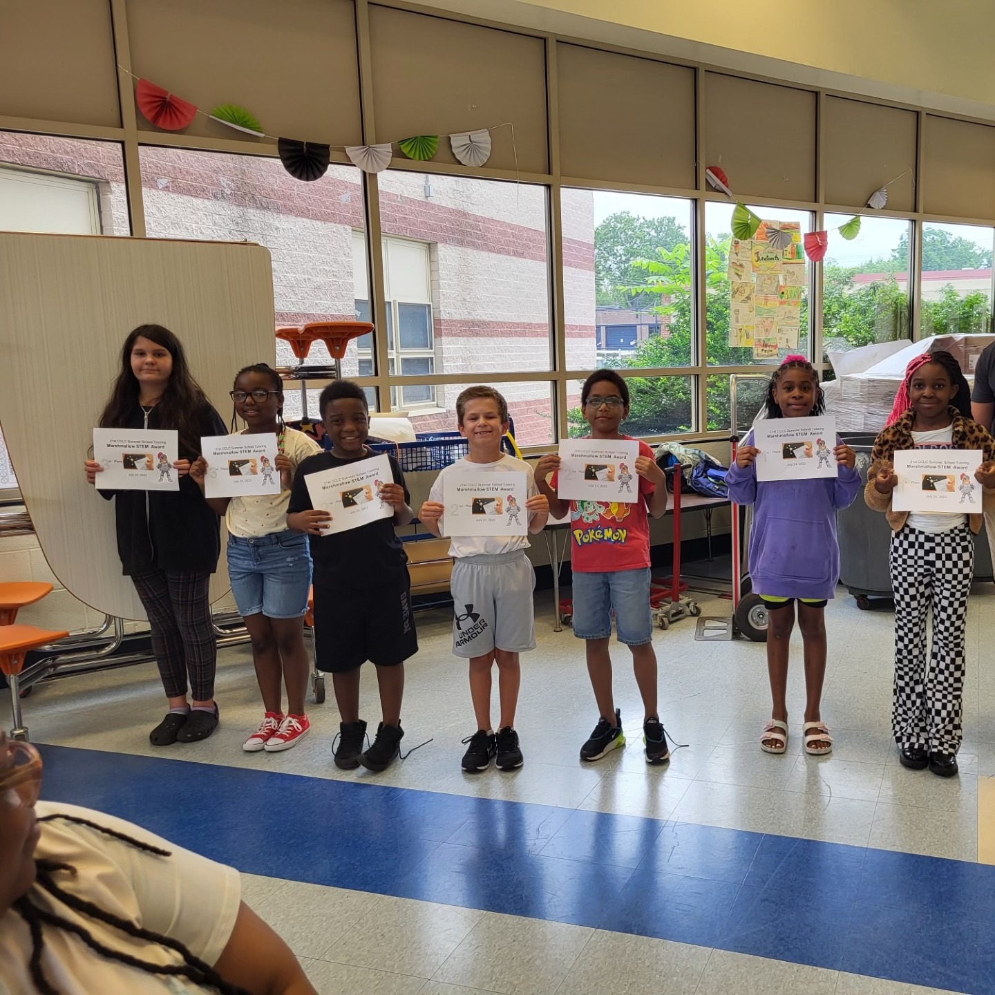 students holding certificate for STEM activity