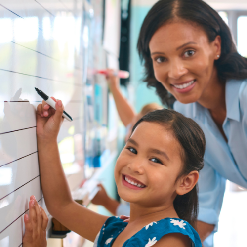 student and teacher smiling