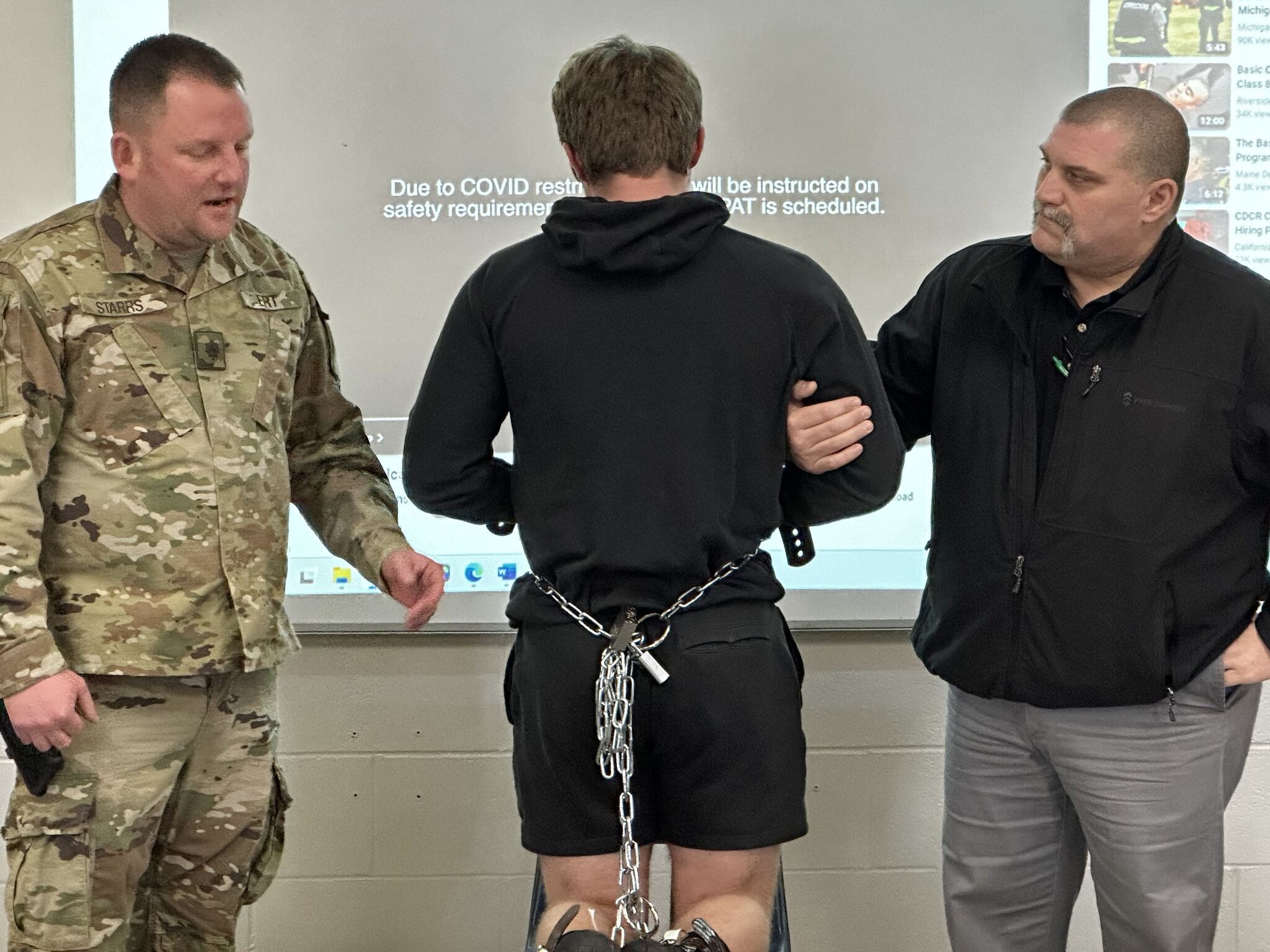 Demonstrating on a student how shackles work.