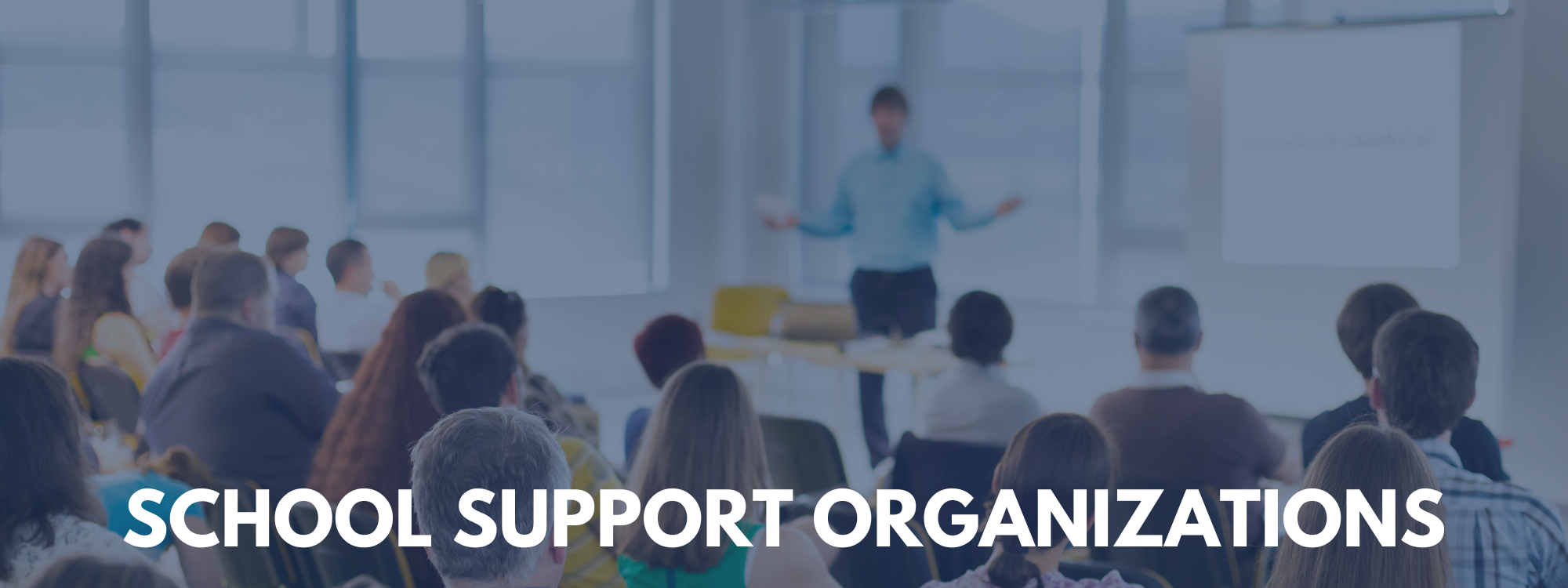 lurred image of an adult presenter speaking to a seated audience in a classroom or meeting space, with the text ‘School Support Organizations’ displayed across the bottom.