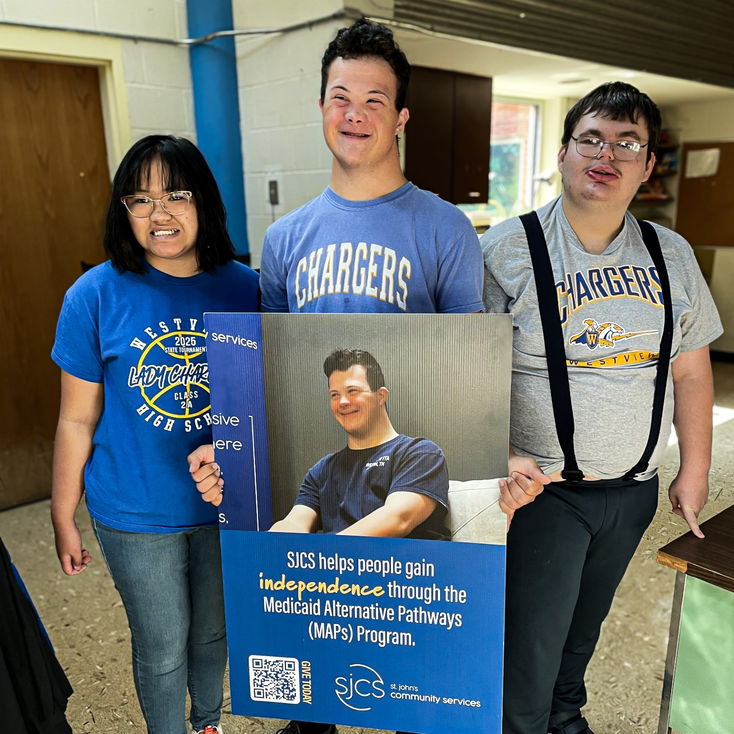students hold an acceptance poster