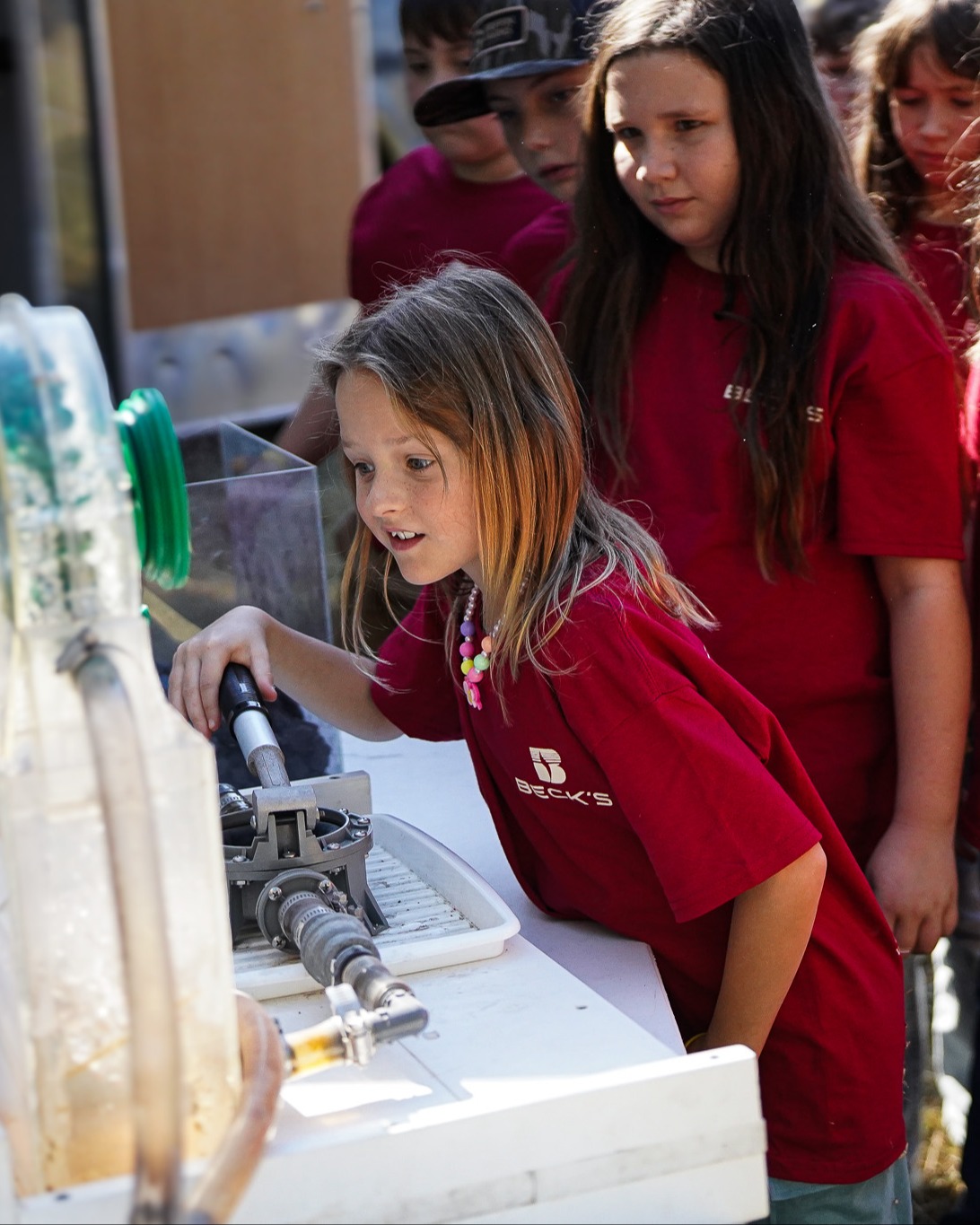 a student interacts with a farm day display