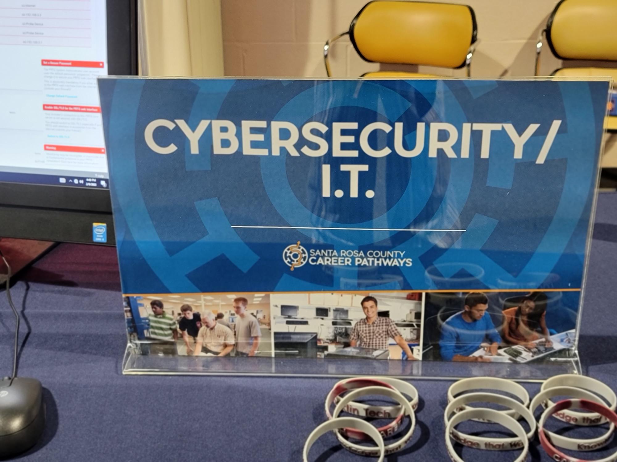A display board in a room with information about cyber security and related events.