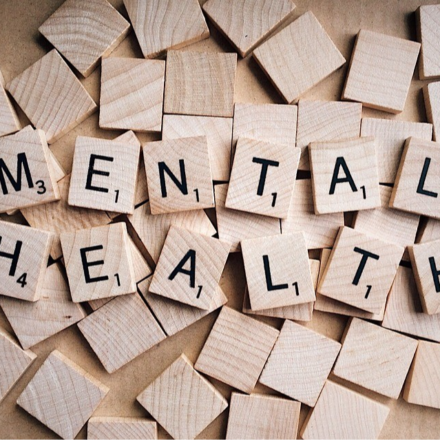 A collection of jigsaw puzzle pieces forming the word 'mental health' against a white background.