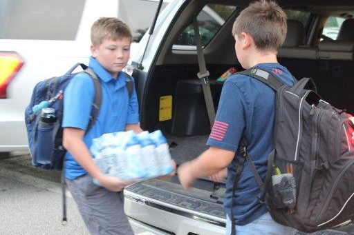 students holding water bottles