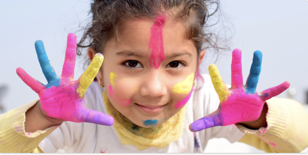 girls with paint in hands looking at camera