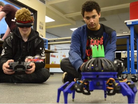 Two boys with remote control robot