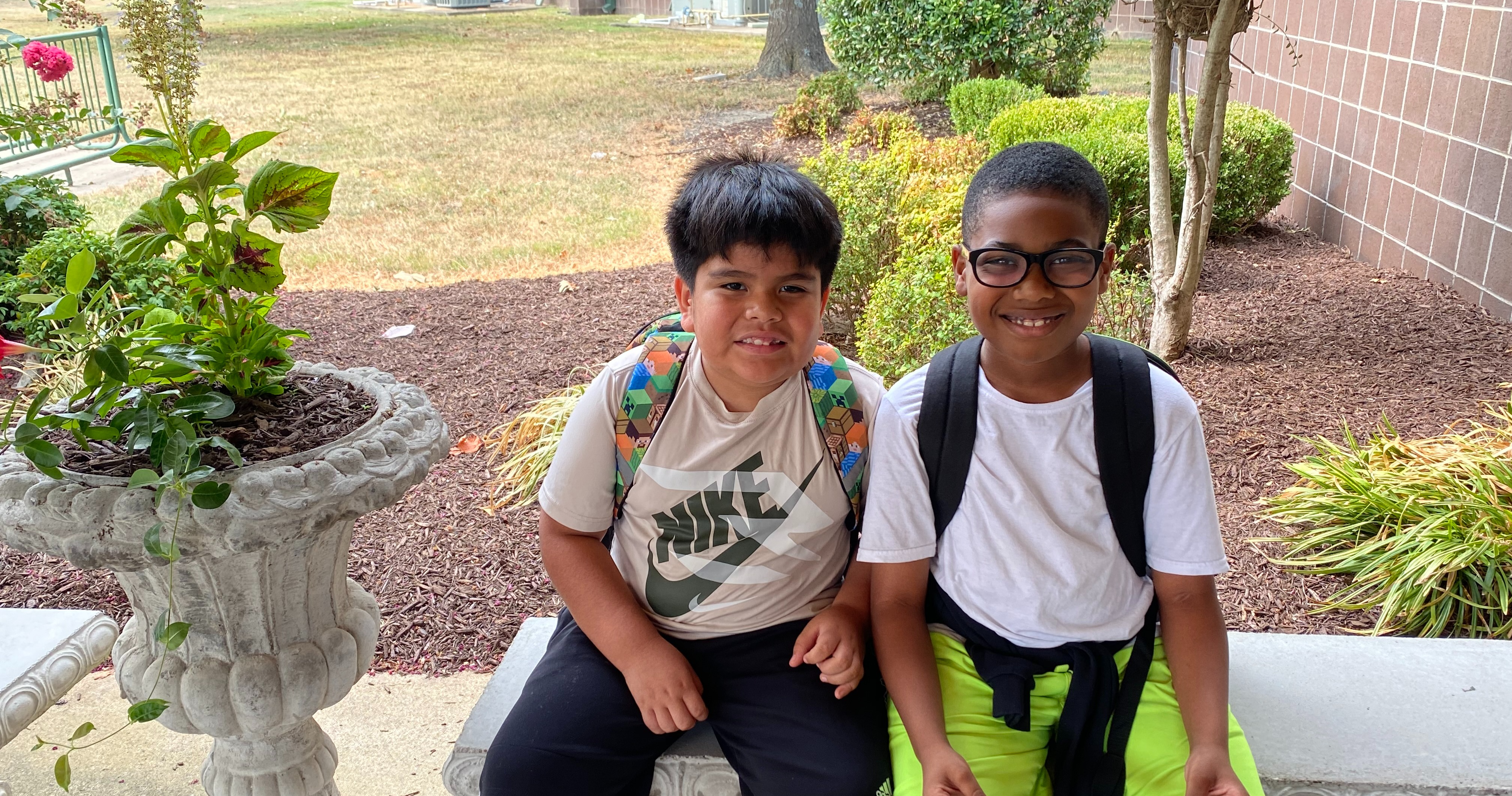 MES students students seated outside