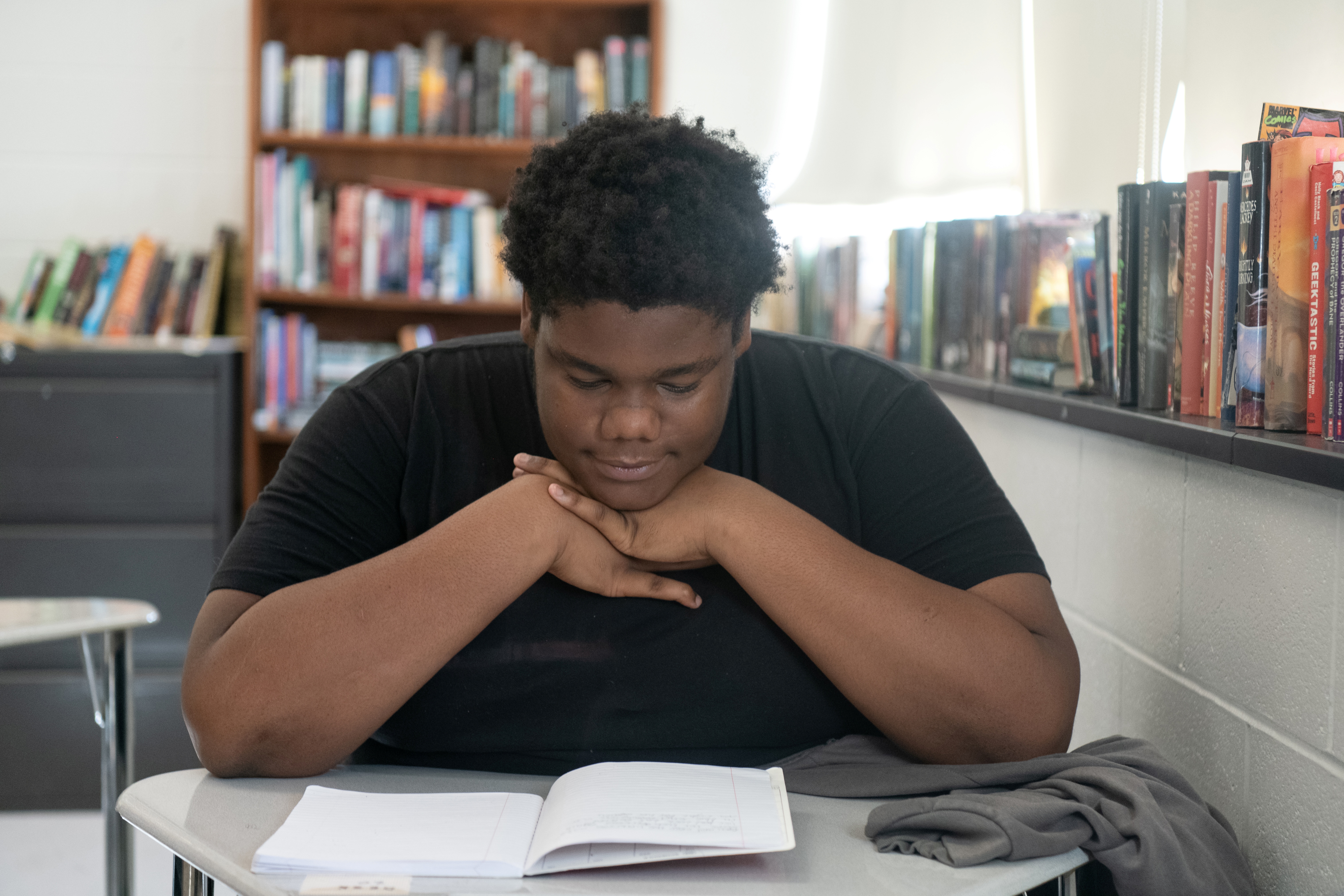 High School student reading notebook