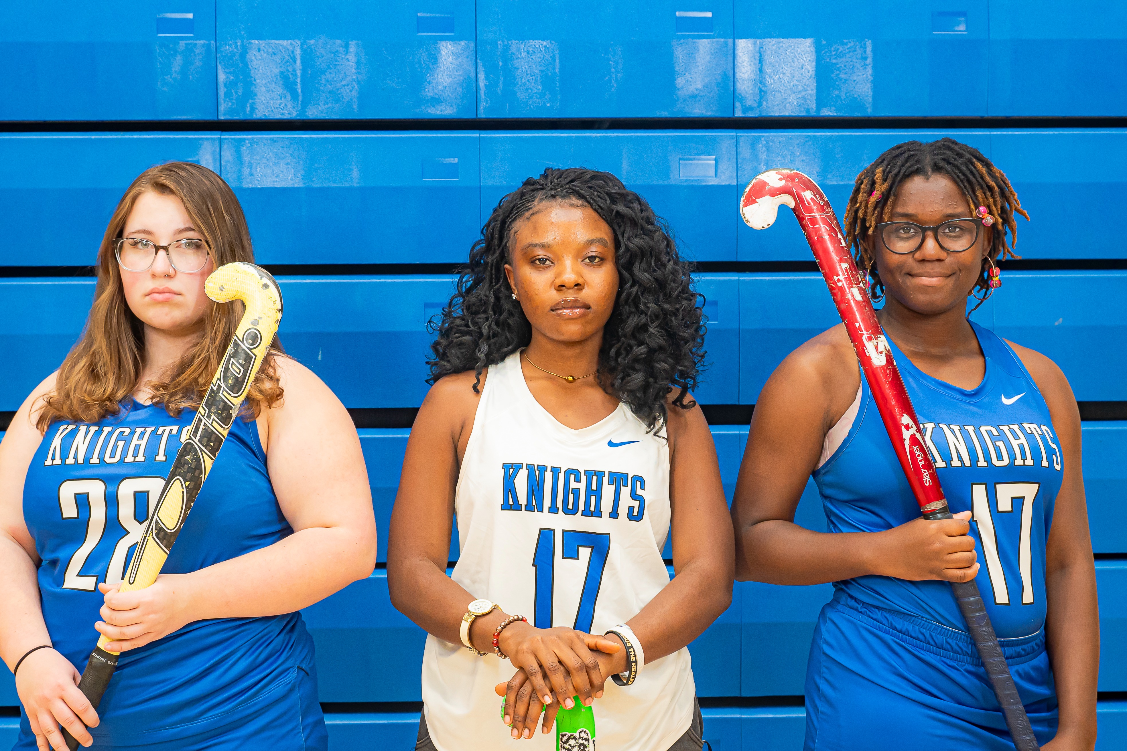 three field hockey players