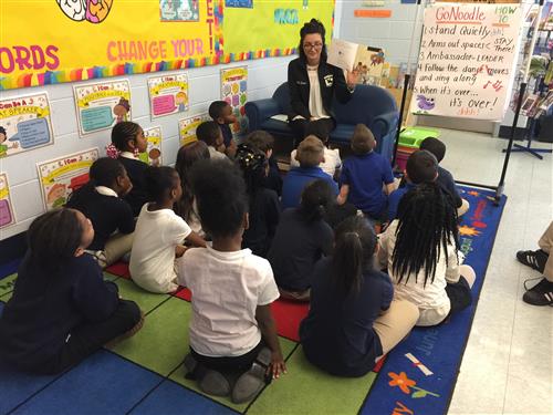 Teacher with students sitting on the carpet