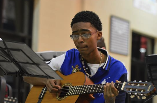 student with a guitar